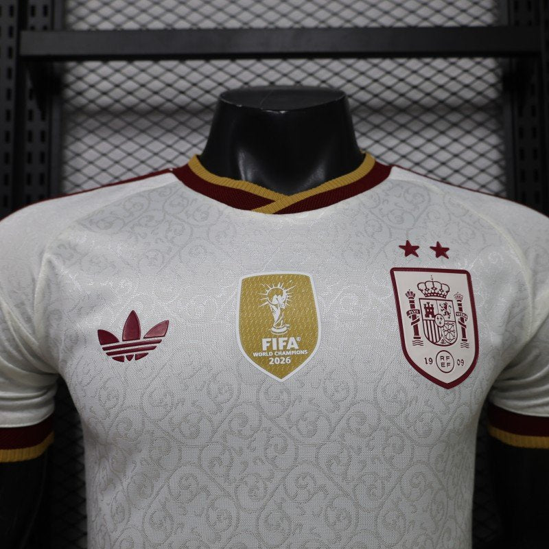 Front detail of the white Spain 2026 World Cup Champions jersey with two stars and centered World Champions badge