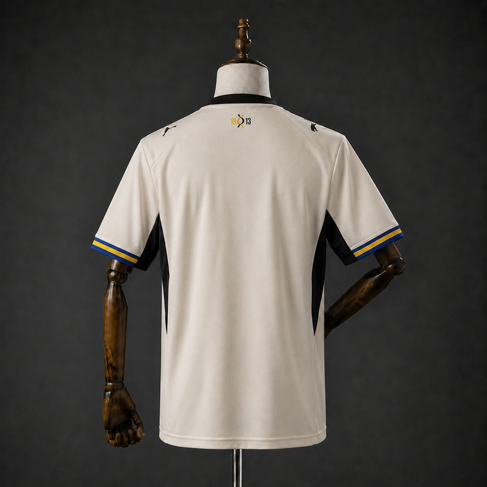 Parma Home Jersey 2026/27 front view with black cross and blue and yellow sleeve trim