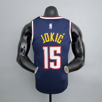 Gold Jokić name and white number 15 with red outline on jersey back