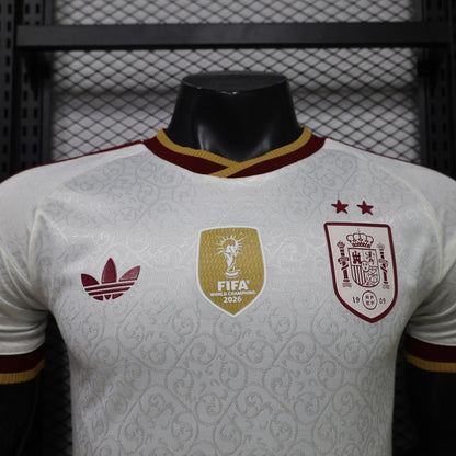 Front detail of the white Spain 2026 World Cup Champions jersey with two stars and centered World Champions badge