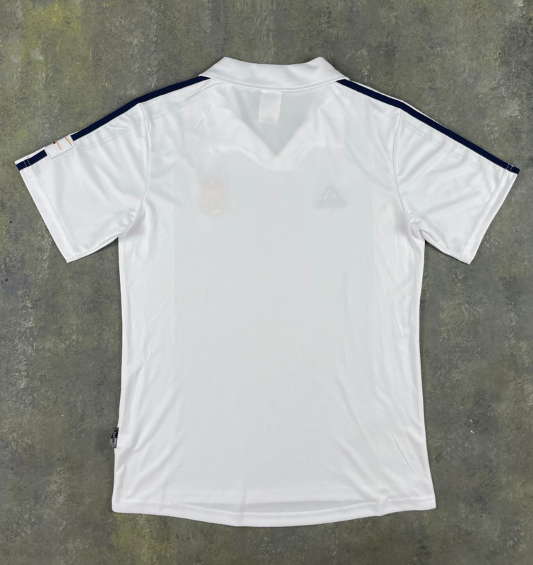 Front of white Real Madrid 2001/02 retro home jersey with dark shoulder stripes and fold-over collar