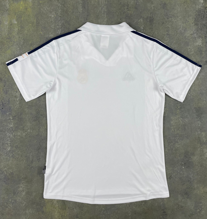 Front of white Real Madrid 2001/02 retro home jersey with dark shoulder stripes and fold-over collar