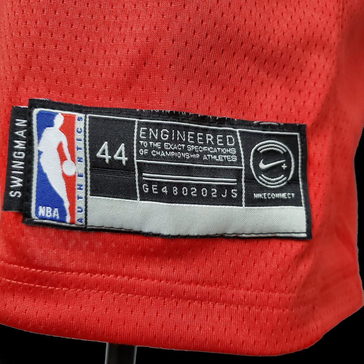 Bulls lettering and number 23 in black with white outlines on red jersey