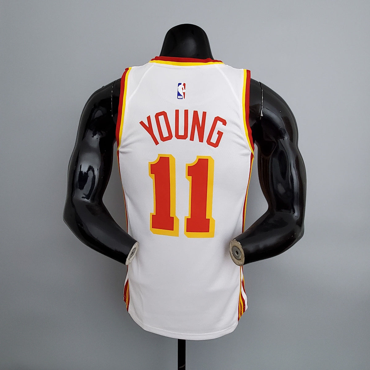 Close-up of Atlanta lettering and number 11 on white basketball jersey front