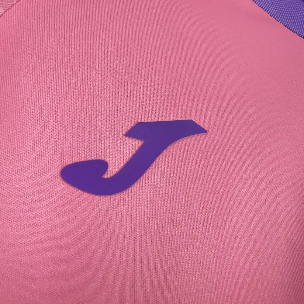 Purple chest logo and pink fabric close-up on the Hoffenheim Pink October Jersey 2025/26