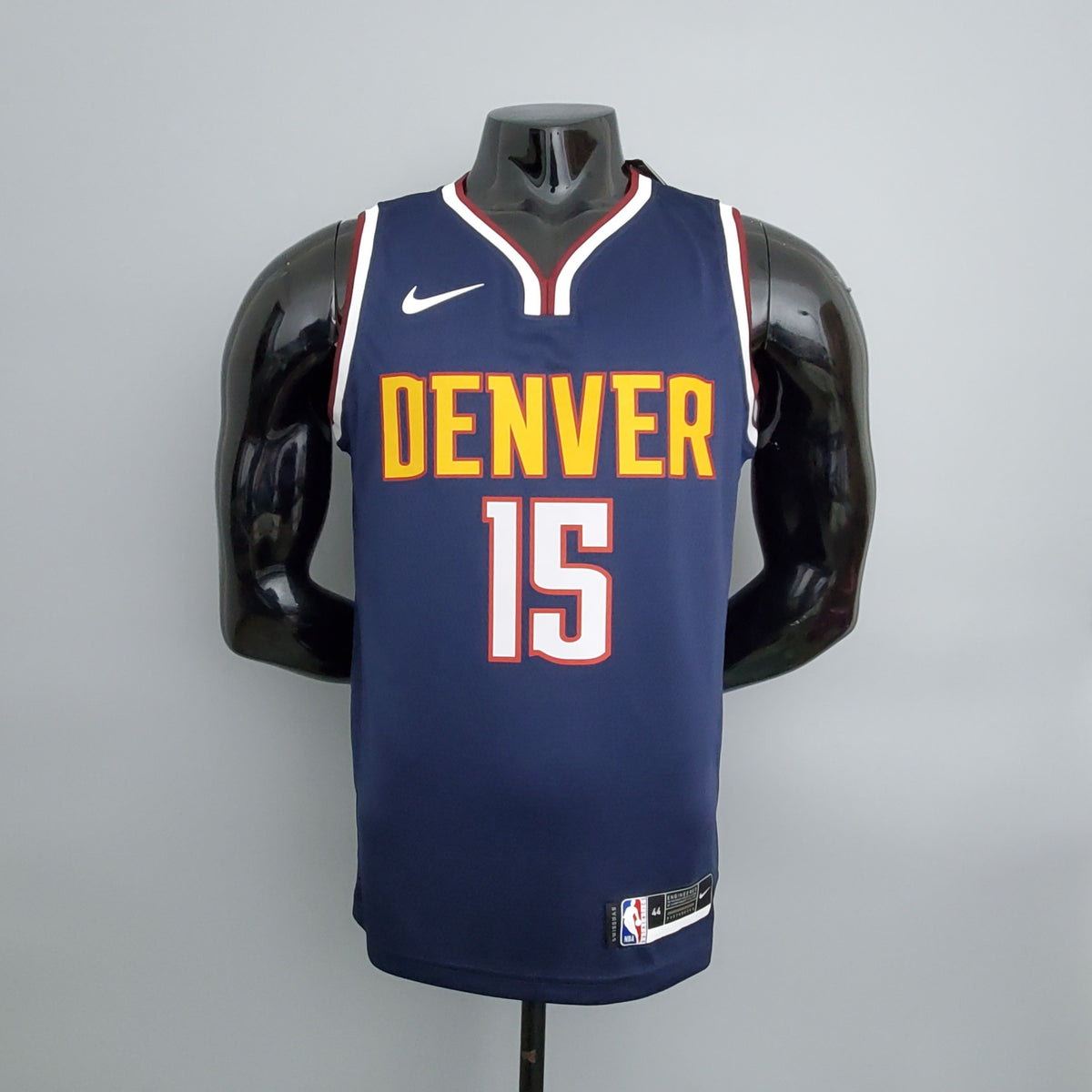 Gold Denver lettering and white number 15 outlined in red on navy jersey