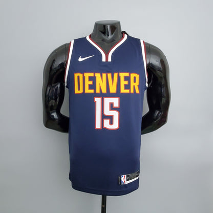 Gold Denver lettering and white number 15 outlined in red on navy jersey