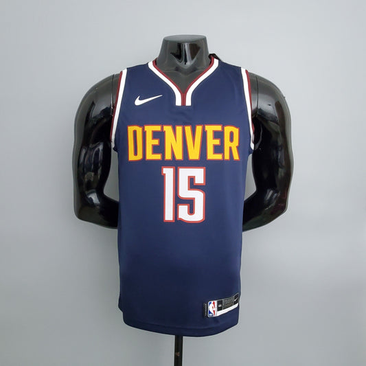 Gold Denver lettering and white number 15 outlined in red on navy jersey