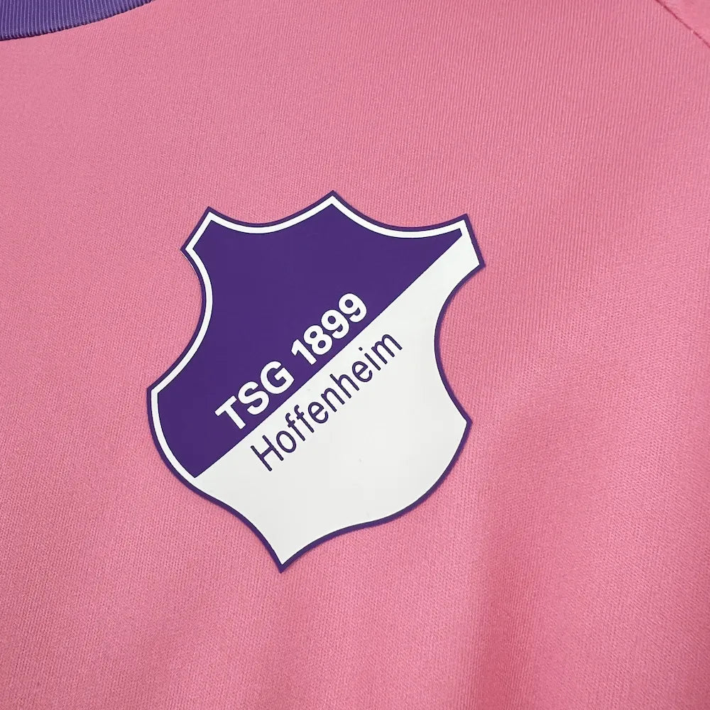 Purple-and-white Hoffenheim crest close-up on the Pink October Jersey 2025/26