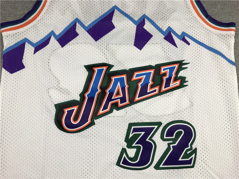 Malone name and purple number 32 with green edging on white Utah Jazz jersey back detail
