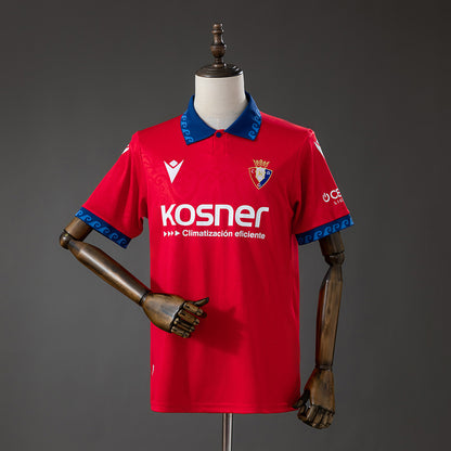 Front view of the red Osasuna 2026/27 home jersey with blue detailing