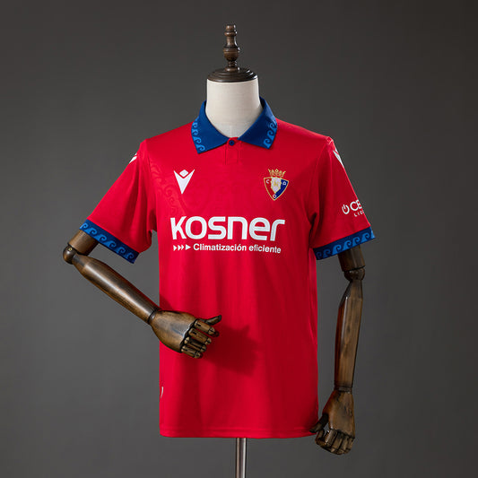 Front view of the red Osasuna 2026/27 home jersey with blue detailing