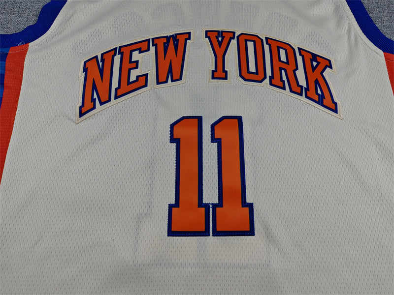 Blue Brunson lettering and orange number 11 back detail on cream Knicks jersey