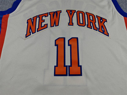 Blue Brunson lettering and orange number 11 back detail on cream Knicks jersey