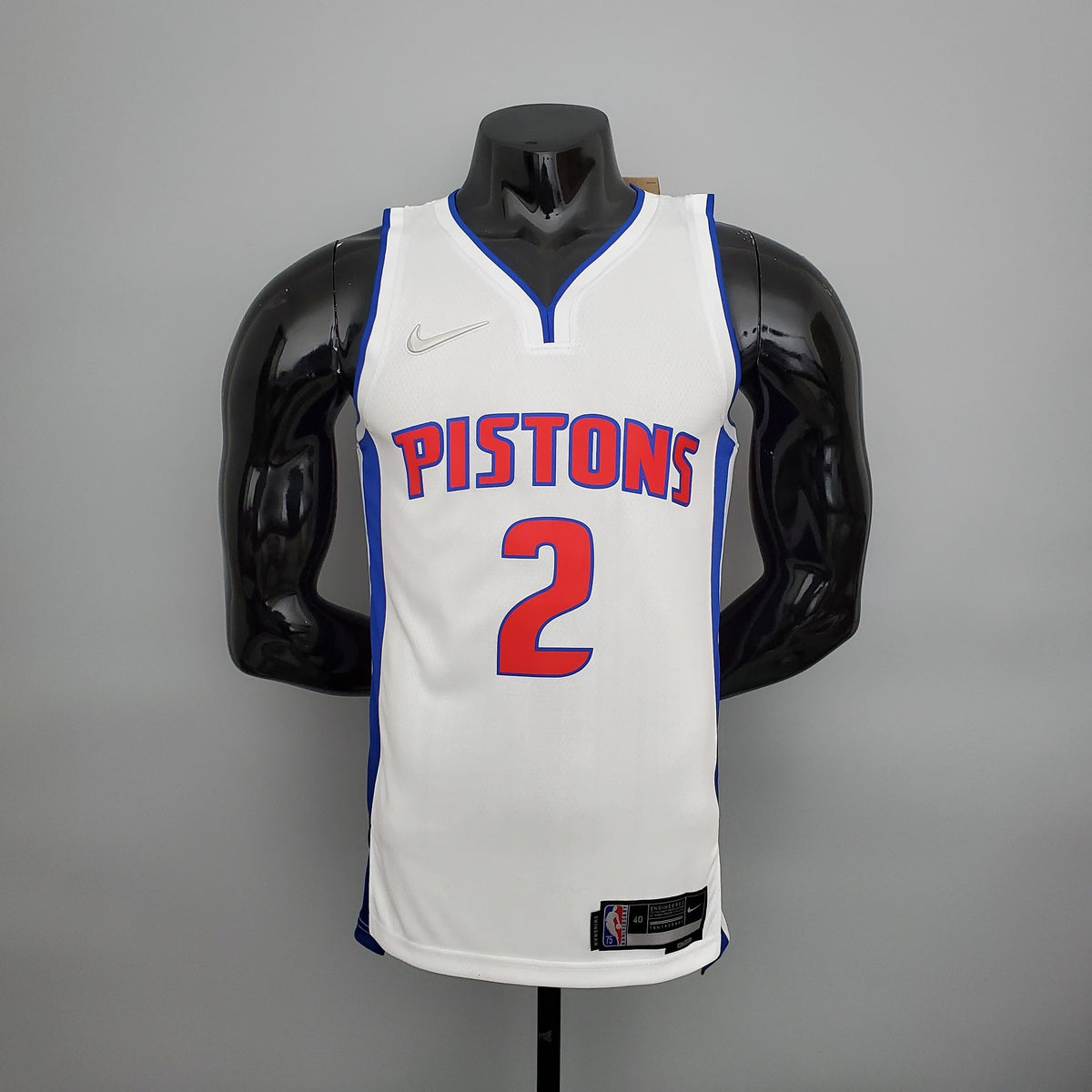 Red Pistons lettering and number 2 outlined in blue on white jersey