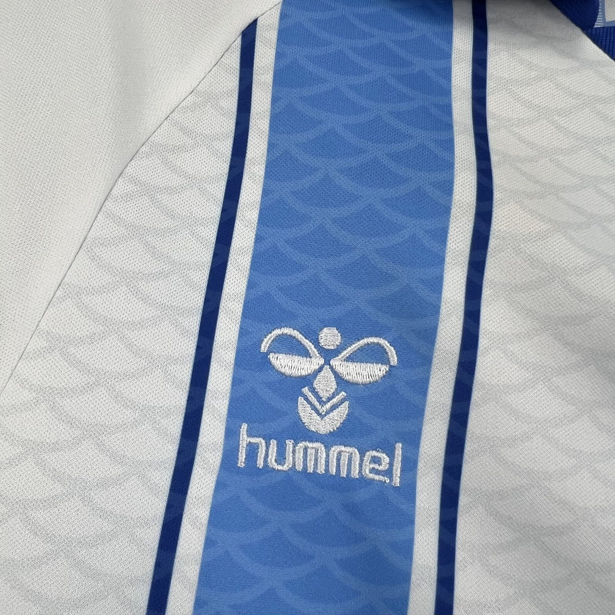 Back view of the white and light blue Málaga 2026/27 home jersey